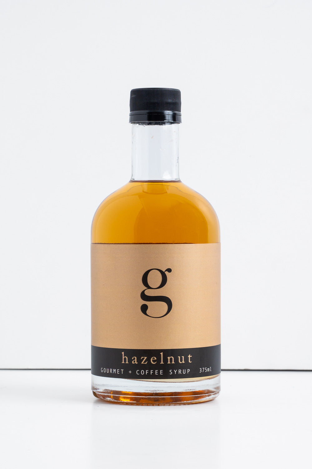 Bottle of Gourmet Inspirations Hazelnut Gourmet + Coffee Syrup – nutty and sweet flavor enhancer.